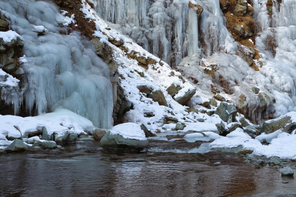 Snow on Rocks by the Stream